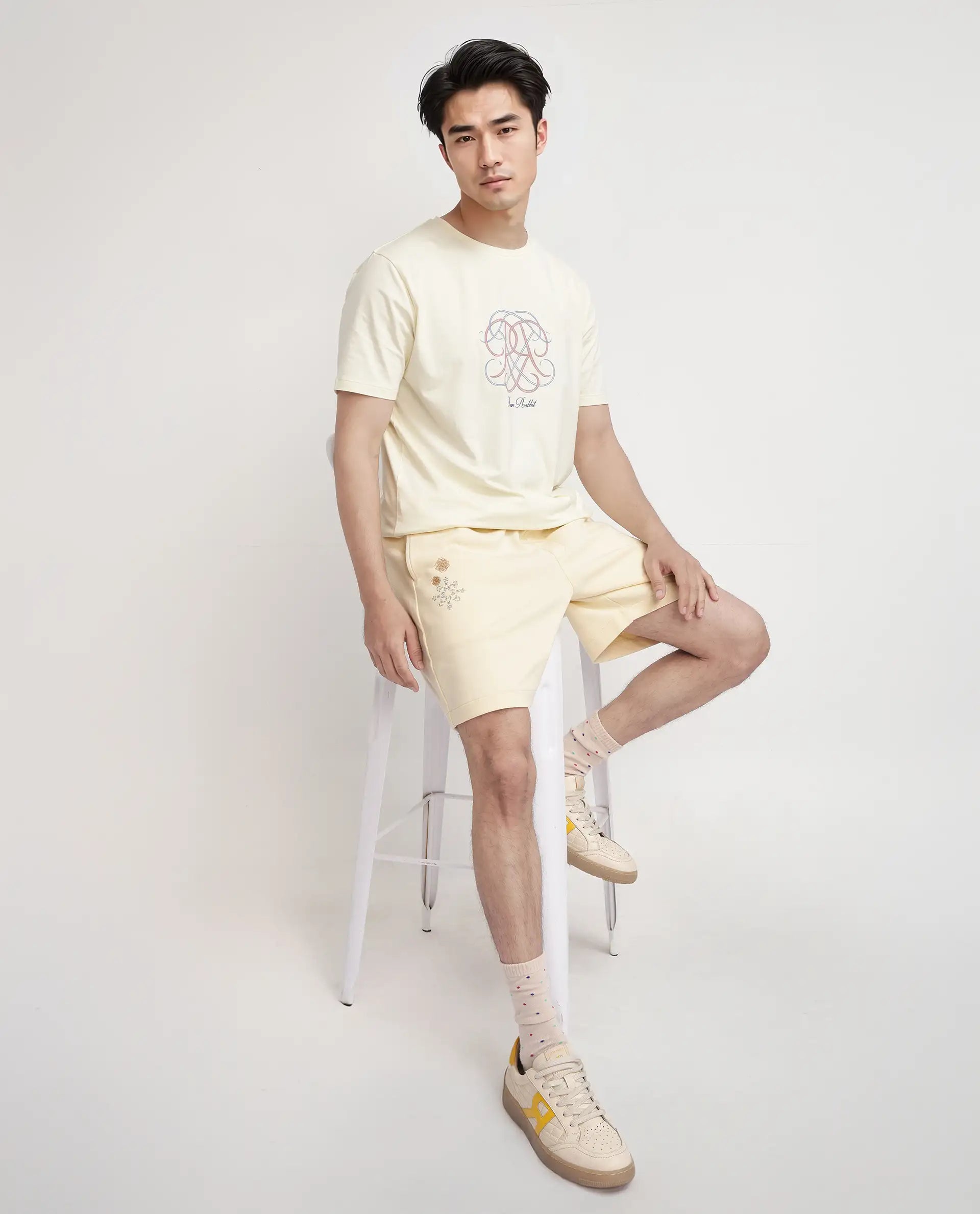 Men's Pants with Logo EmbossmentsRare Rabbit Men Enox Pastel Yellow Cotton Elastane Fabric Plain Shorts