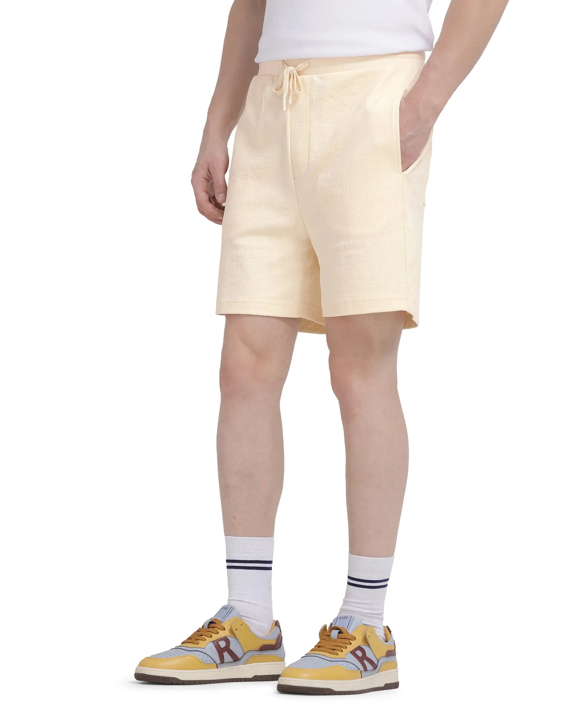Men's Pants with Button-CuffsRare Rabbit Men Kelor Pastel Yellow Cotton Elastane Fabric Drawstring Closure Back Label Plain Shorts