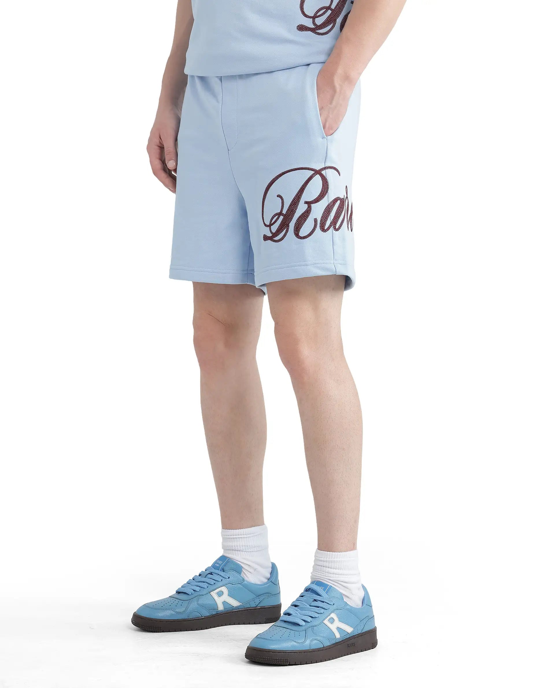 Men's Pants with Faux Leather PatchesRare Rabbit Men Loito Light Blue Cotton Elastane Fabric Drawstring Closure Relaxed Fit Embroidered Shorts